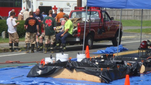  Emergency personnel is taking a break and hydrating with water.